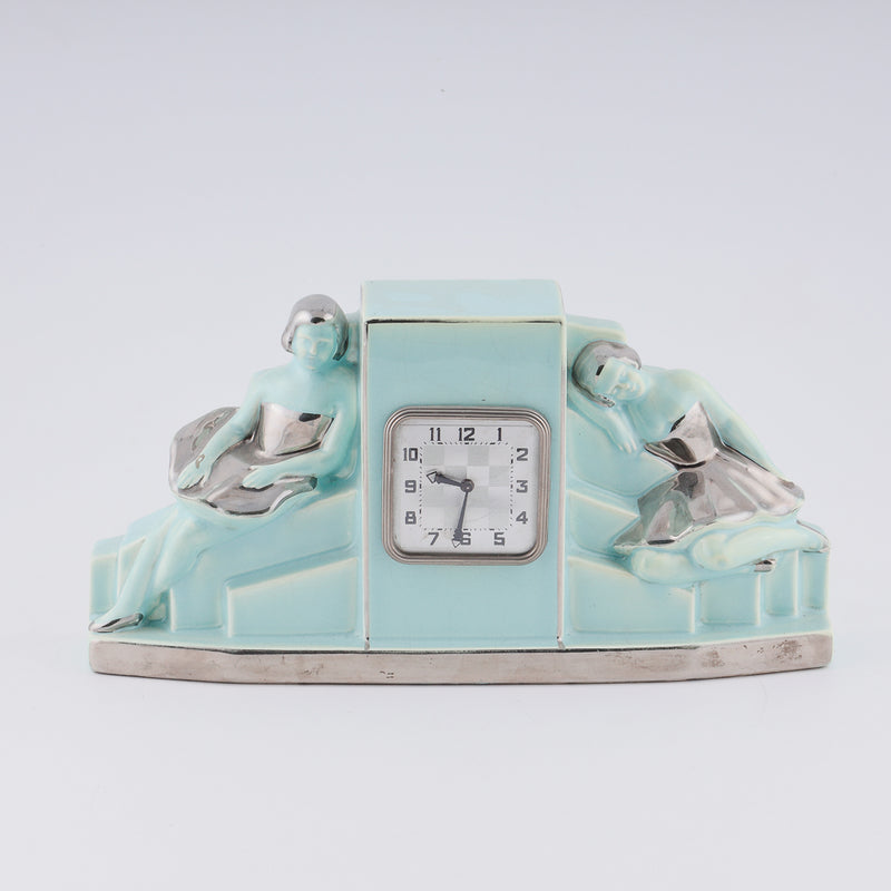 Fajance Art Deco clock shaped in a pedestal form with two elegant ballerinas sitting gracefully at each side