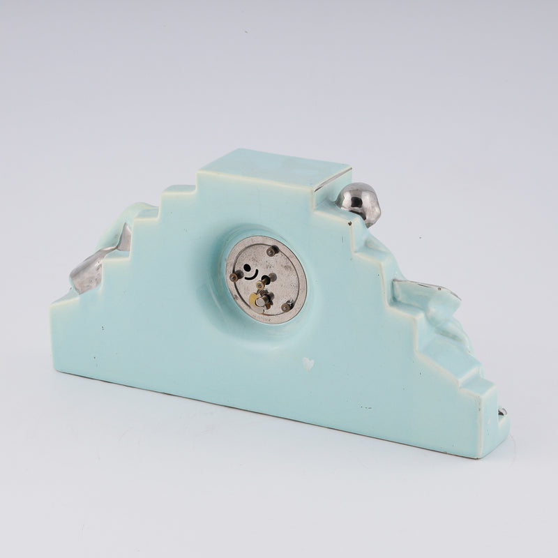 Fajance Art Deco clock shaped in a pedestal form with two elegant ballerinas sitting gracefully at each side