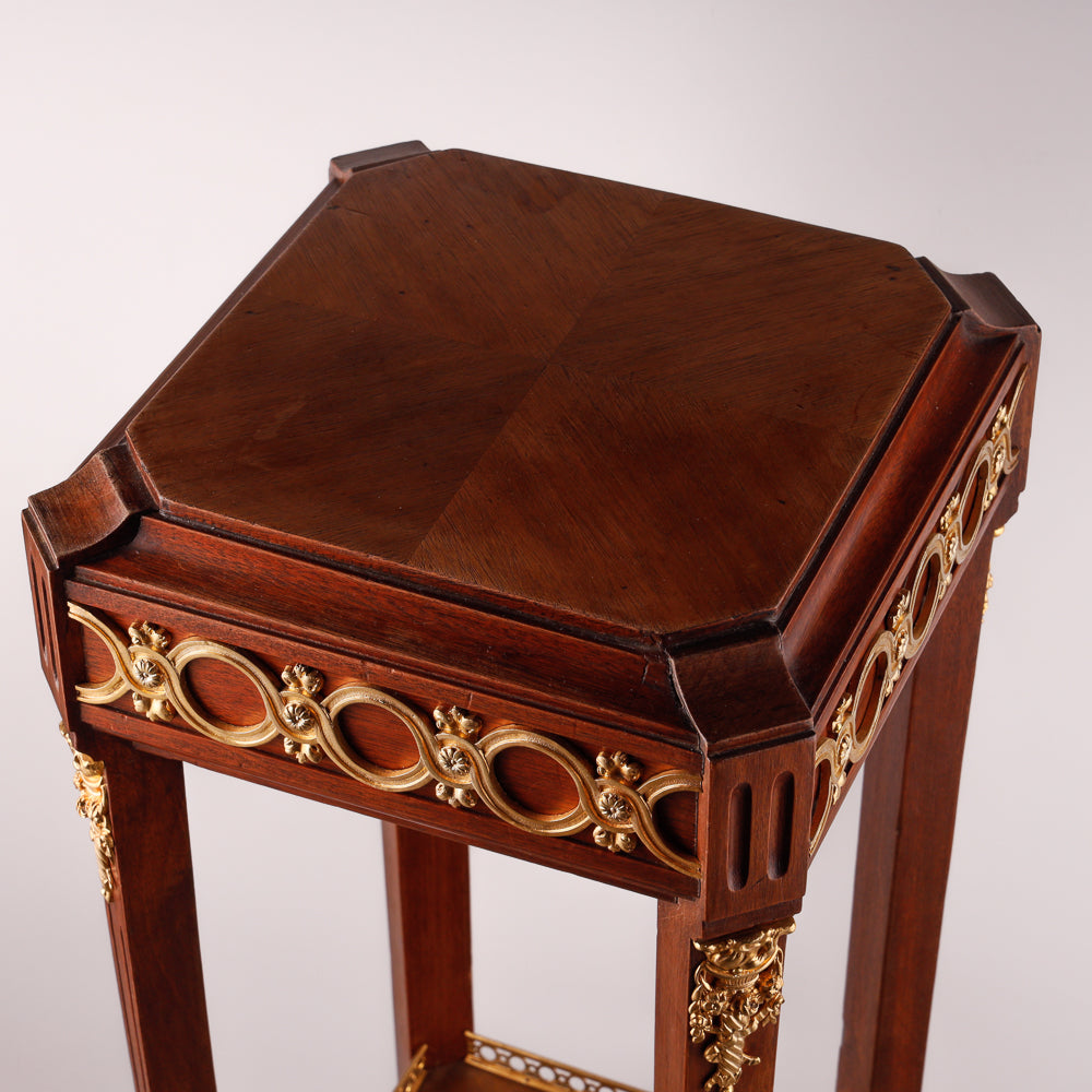 Mahagony hand-carved console with gold-painted Neoclassical decorative ornaments.