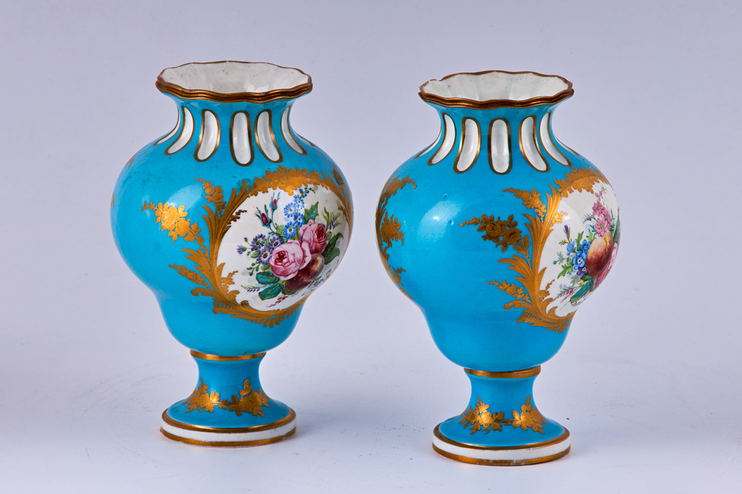 Pareja de jarrones de porcelana azul de Sevres pintados a mano con decoración policromada