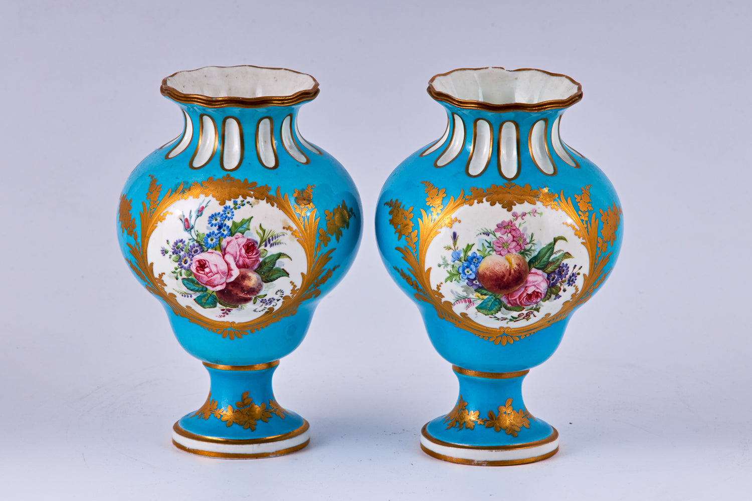 Pareja de jarrones de porcelana azul de Sevres pintados a mano con decoración policromada
