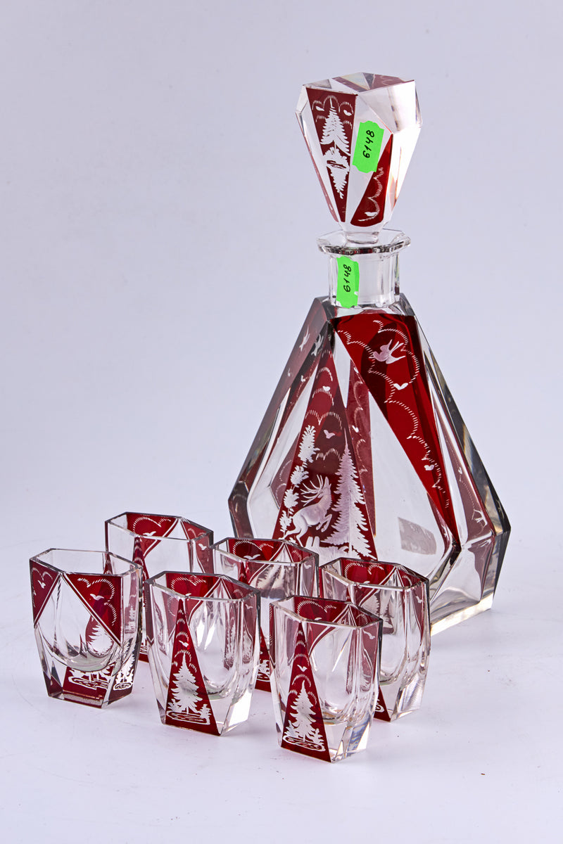 A stunning Czechoslovakian hand-carved crystal vodka carafe with 6 vodka cups