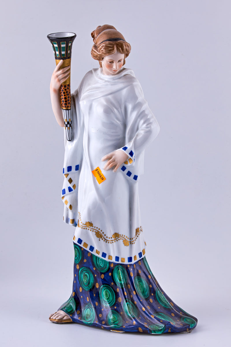 Hand-painted porcelain figurine of a woman with a torch
