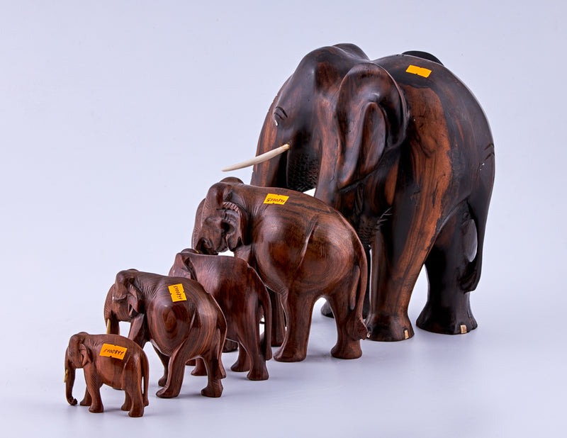 Vintage set of five wooden elephants with ivory tusks