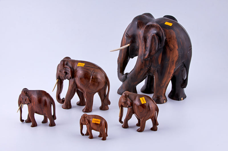 Vintage set of five wooden elephants with ivory tusks