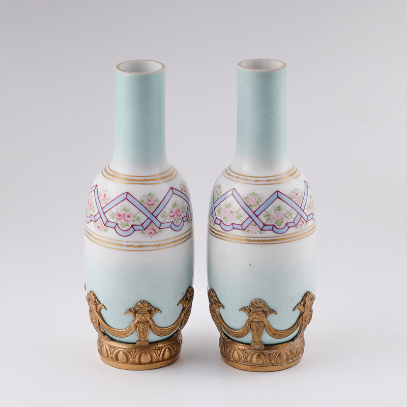 Antique Pair of French small decorative porcelain vases in a gilt bronze setting