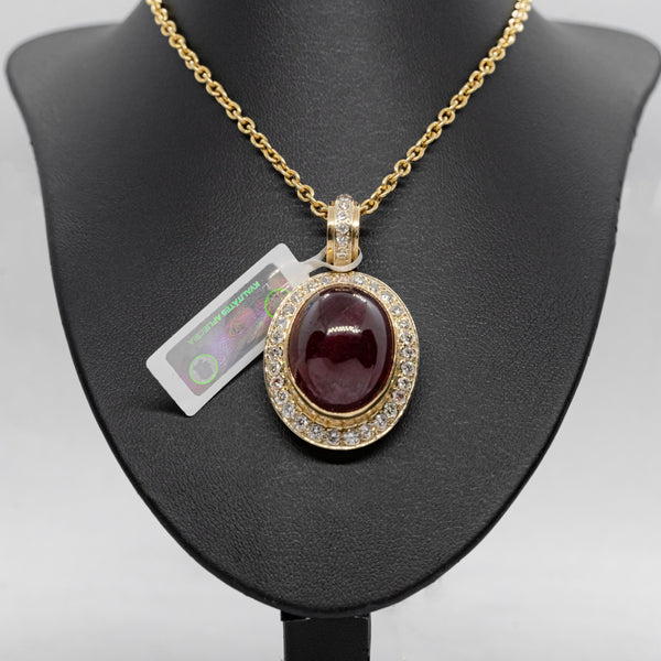 Vintage 14k yellow gold necklance with a pendant set with natural diamonds and Cabochon cut ruby