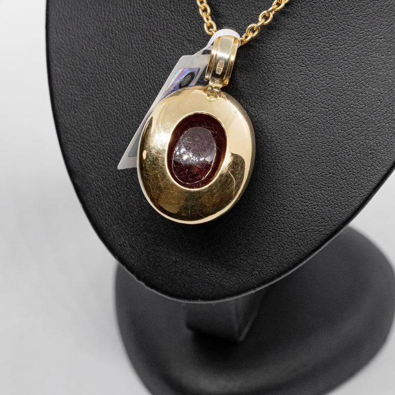 Vintage 14k yellow gold necklance with a pendant set with natural diamonds and Cabochon cut ruby
