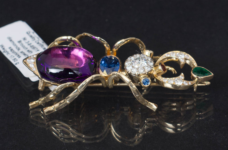 14k yellow gold pin brooch in a design of a bug set with natural diamonds, tanzanite, amethyst and emerald
