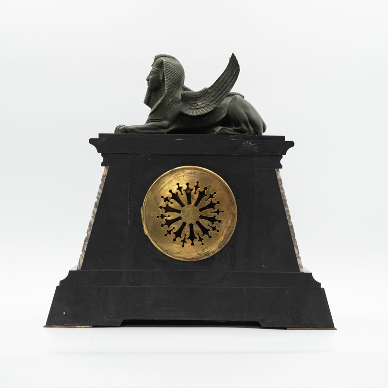 Antique marble mantel clock with an Egyptian motif decorated with a winged sphinx on top