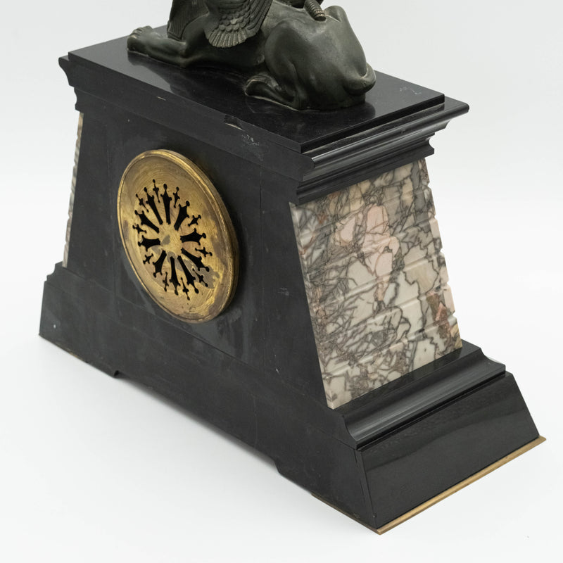 Antique marble mantel clock with an Egyptian motif decorated with a winged sphinx on top