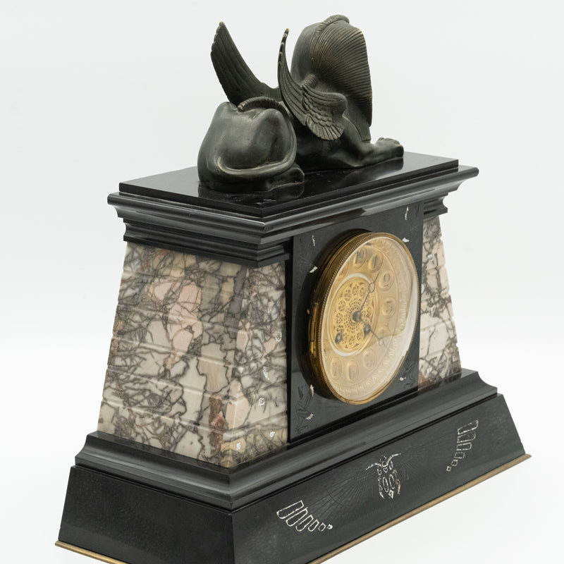 Antique marble mantel clock with an Egyptian motif decorated with a winged sphinx on top