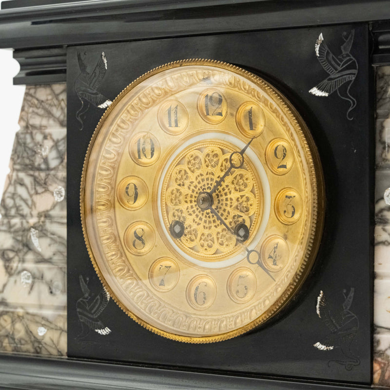 Antique marble mantel clock with an Egyptian motif decorated with a winged sphinx on top