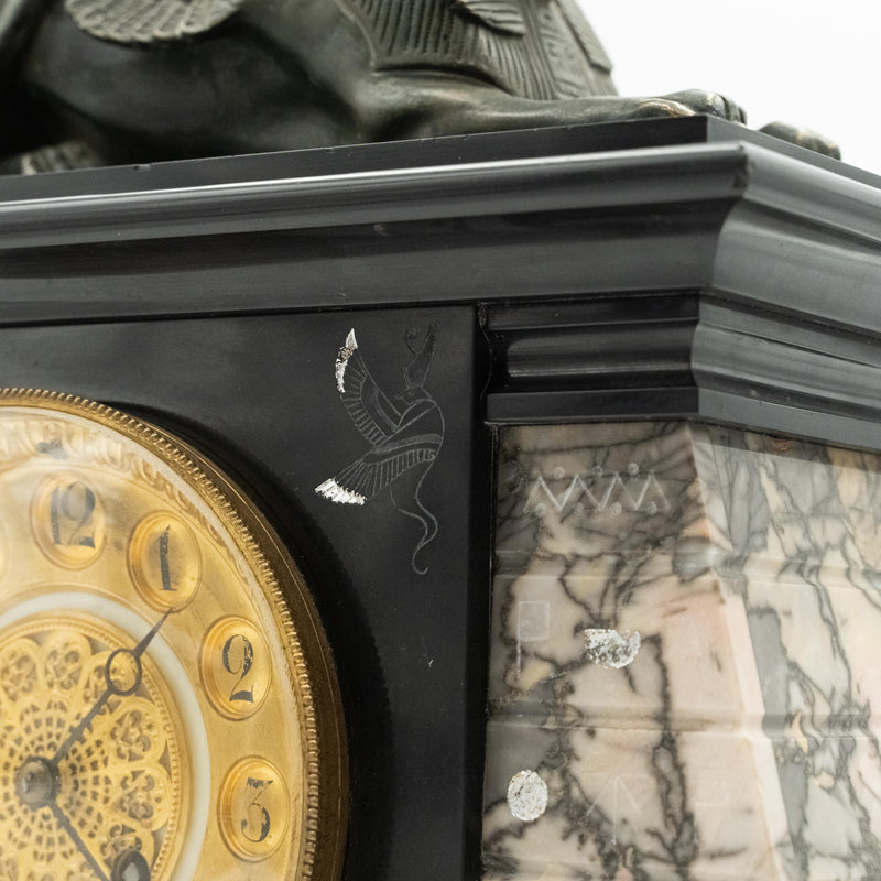 Antique marble mantel clock with an Egyptian motif decorated with a winged sphinx on top