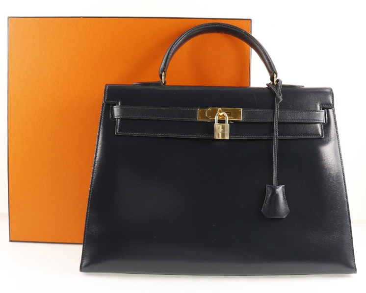 Hermés Kelly 25cm Correa de piel de becerro azul marino y con caja 